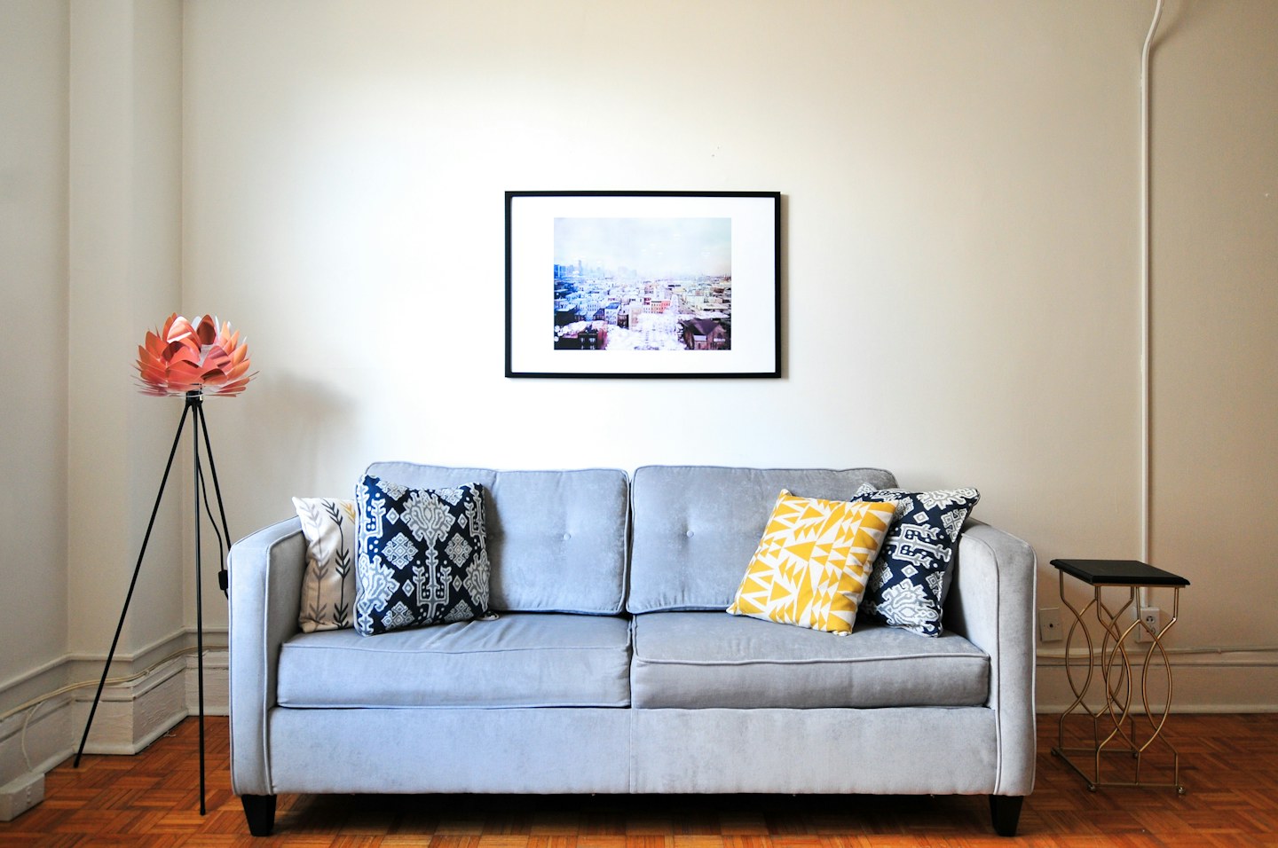Blue loveseat and artworks in a bright apartment
